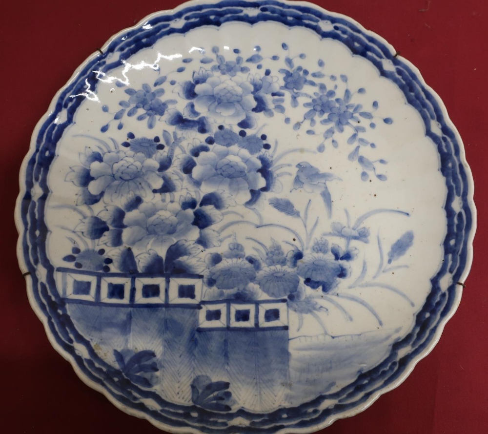 Japanese waved edge circular blue and white charger, all over decorated with chrysanthemums on a