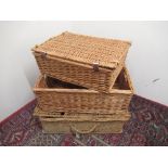 Two wicker picnic baskets and a wicker storage container