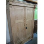 Craftsman made pine wardrobe with two panel doors above two drawers on bun turned feet W130cm H200cm