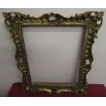 20th C gilt wood and gesso rectangular picture frame with pierced and scroll decoration, aperture