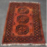 20th C Caucasian rug, burnt orange ground, three central octagonal medallions, in geometric