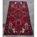 20th C Caucasian Iranian pattern rug, red ground central geometric medallion surrounded by exotic