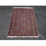 20th C Caucasian rug, green ground with central geometric pattern surrounded by floral and animal