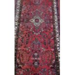 20th Century traditional pattern runner, red ground with central floral pattern ground and geometric