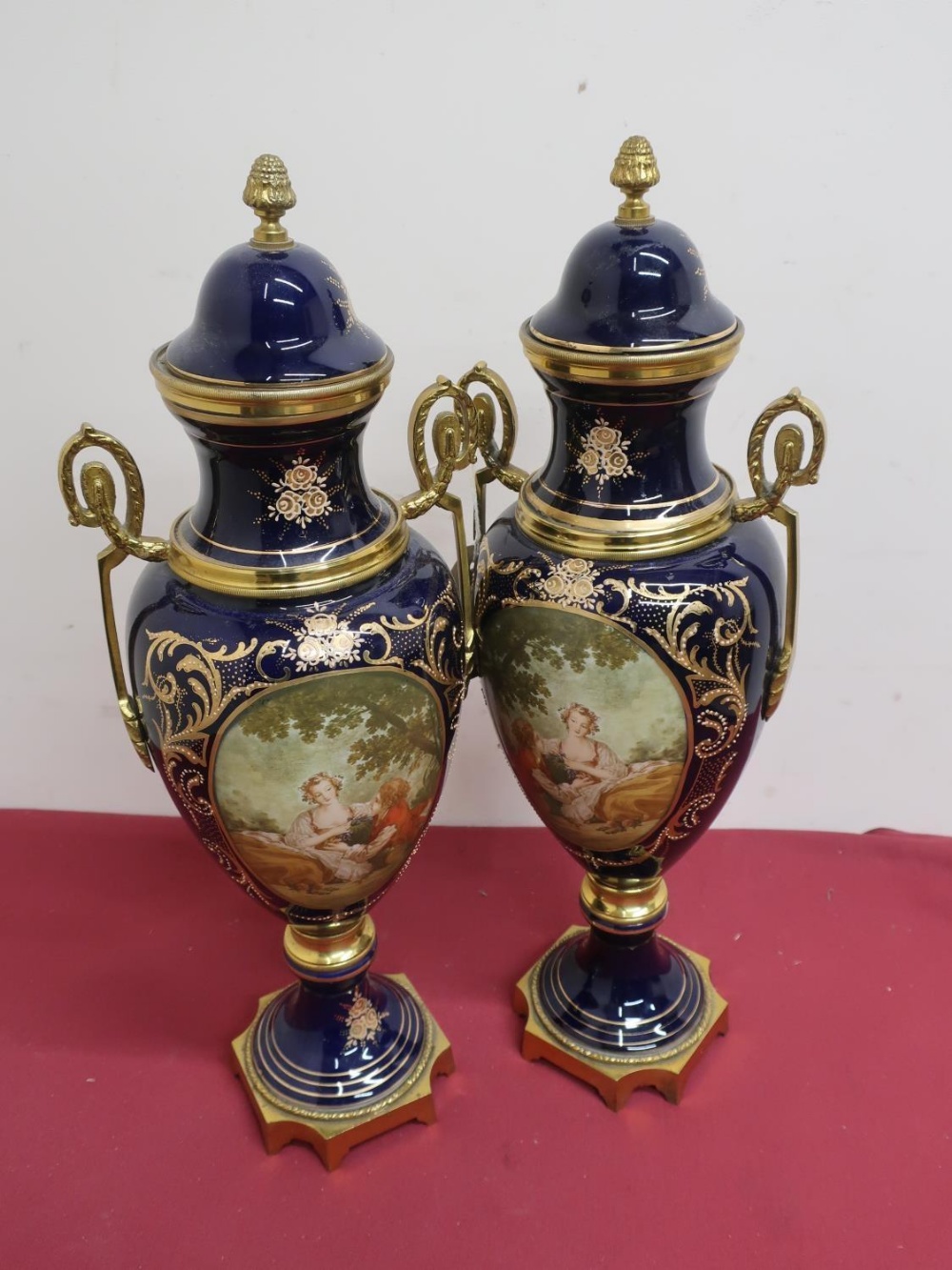 Pair of Serves style gilt metal mounted urn shaped vases and covers, bodies decorated with lovers in