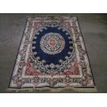 20th C silk style traditional pattern rug, blue ground with central stylized floral medallion and