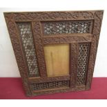 Moorish hardwood rectangular picture frame, carved with scrolling leafage and pierced hexagonal