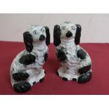 Pair of late Victorian Staffordshire fire side spaniels with green sponged decoration, H20cm (2)