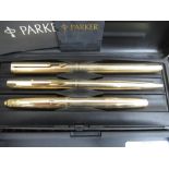 Two Parker cased pen sets, shells, two Corgi die-cast model vehicles, commemorative crowns, and