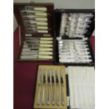 Cased set of six tea knives with hallmarked silver handles (marks rubbed), and two cased sets of