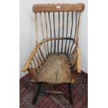 Country made rustic armchair with stick back, curved arms with solid shaped seat, the out-splayed