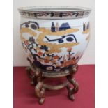 Japanese fishbowl, the exterior decorated in Imari pallette with trailing foliage, the interior with