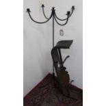 Victorian cast iron fender, W97cm D28cm H15cm, and a wrought metal five light candle stand,