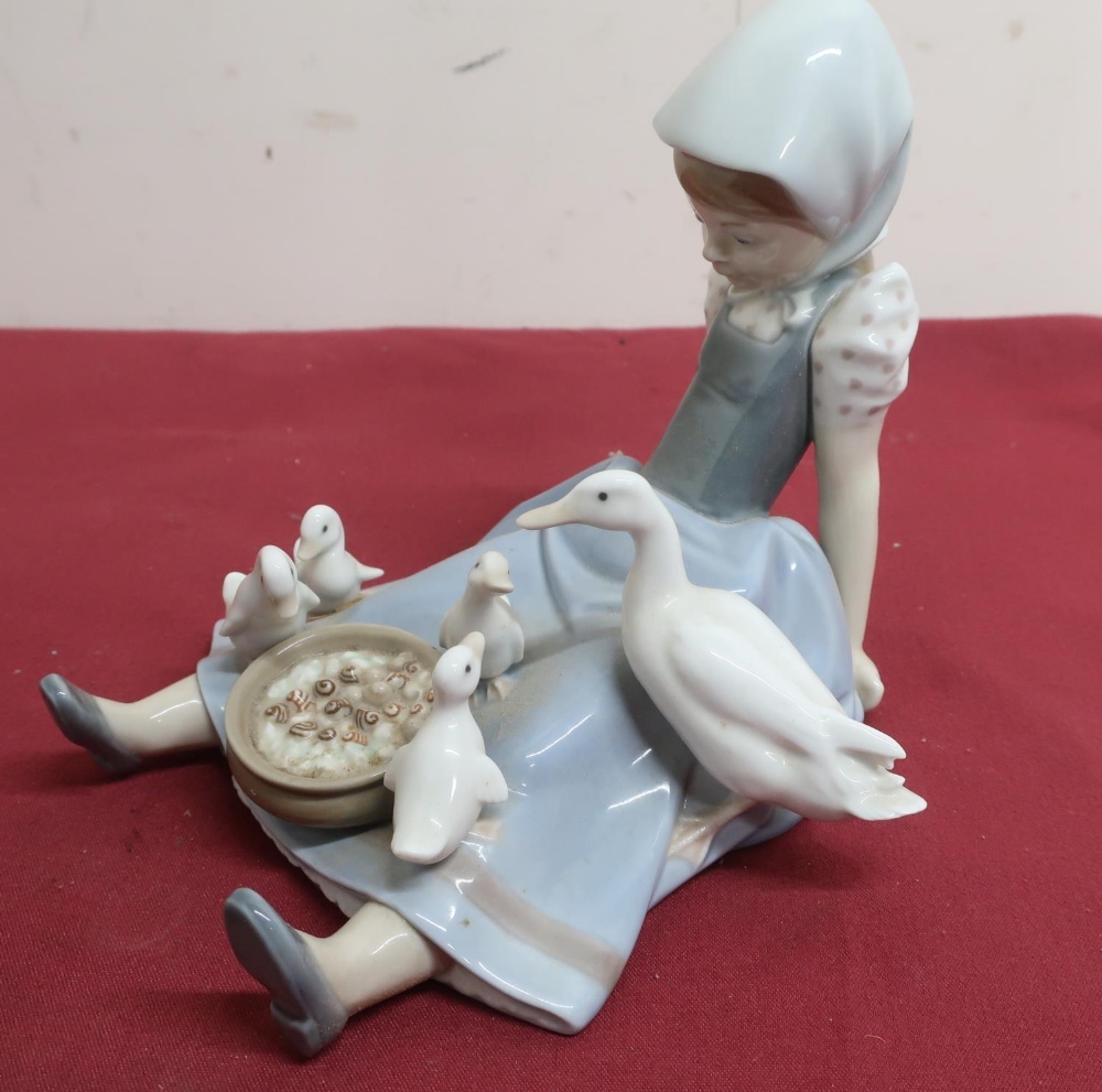 Lladro porcelain figure of a girl seated feeding a duck and ducklings, No 5074, in original box