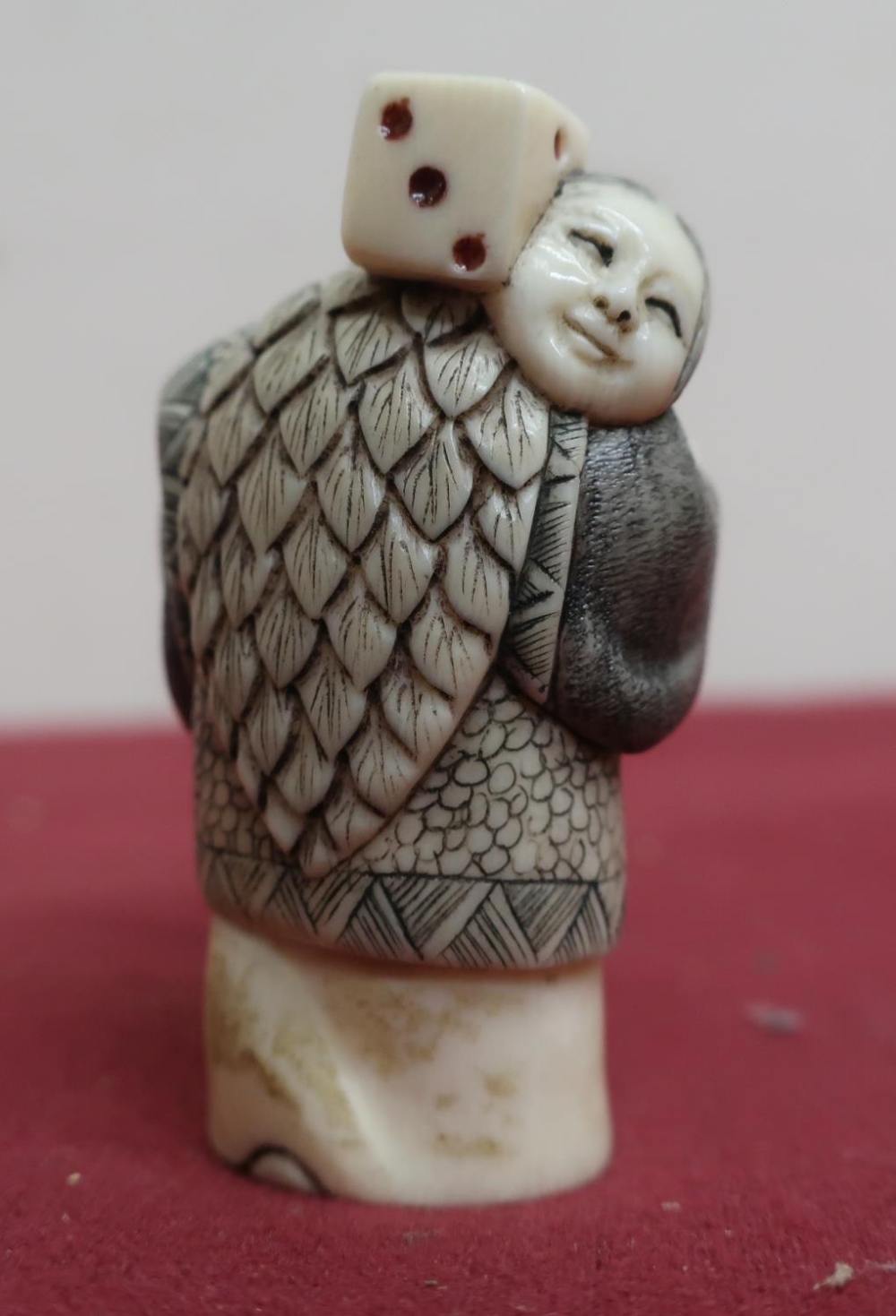 Small late 19th C carved ivory Okimono of a figure carrying a dice, with scratched decoration, - Image 2 of 4