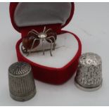 Silver and amber spider brooch, silver hallmarked thimble and another thimble stamped Dorcas CH 7 (