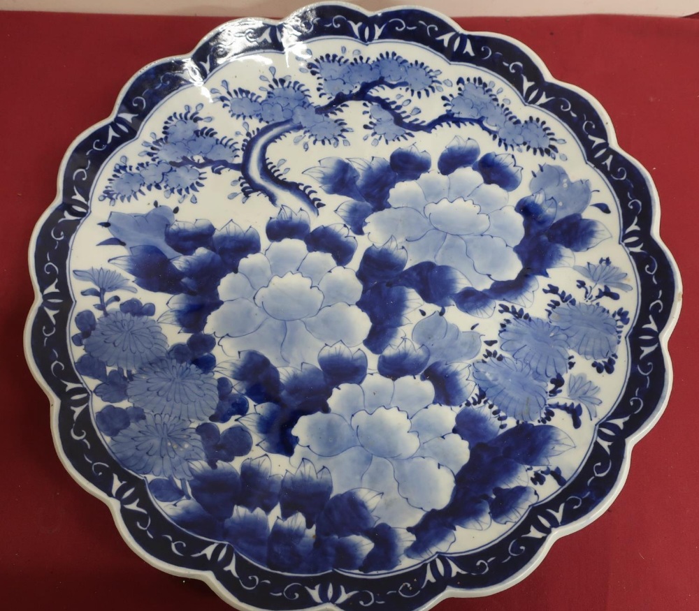 Japanese waved edge circular blue and white charger, all over decorated with chrysanthemums,