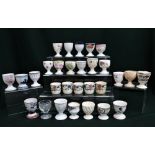 Collection of egg cups including Mintons, Royal Doulton, Royal Cauldron, Paragon, Coalport, Royal