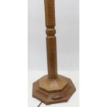 Robert Mouseman Thompson - an oak standard lamp, adzed octagonal tapering column on stepped base,