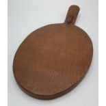 Robert Mouseman Thompson - an adzed oak oval cheeseboard, handle carved with signature mouse L37cm