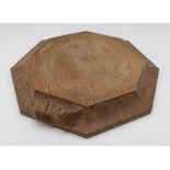 Robert Mouseman Thompson - an adzed oak octagonal teapot stand, carved with signature mouse, D19cm