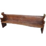 Robert Mouseman Thompson - a massive oak settle of good colour, one piece back with waved carved top