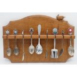 Bob Wren Man Hunter - an oak spoon rack, with arched top and single shelf, carved with signature