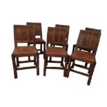 Robert Kingpost Ingham - a set of six oak dining chairs, with triple panel backs and brass nailed