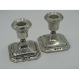 Pair of Geo.V silver hallmarked dwarf candlesticks on square tapering step bases Birmingham 1934