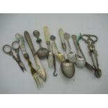 Collection of silver items including teaspoons, grape scissors, sugar nips