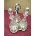 20th century silver-plated three decanter cruet, silver plated tri-form stand on ball feet, the