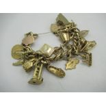 9ct gold hallmarked charm bracelet, hung with eighteen charms, including Edinburgh Castle, Scrabo