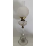 Edwardian clear glass oil lamp, with faceted tapering column,circular base and resevoir, opaque