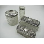 Four early 20th C glass dressing table jars with silver hallmarked tops, Chester and Birmingham