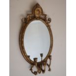 Regency style carved giltwood and gesso girandole mirror, oval plate with portrait cresting, three