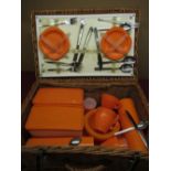 Wicker picnic basket complete with plastic cups, saucers, food storage and a selection of