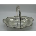 Geo.V1 silver hallmarked swing handled oval cake basket, with C scroll cast border, on four ball