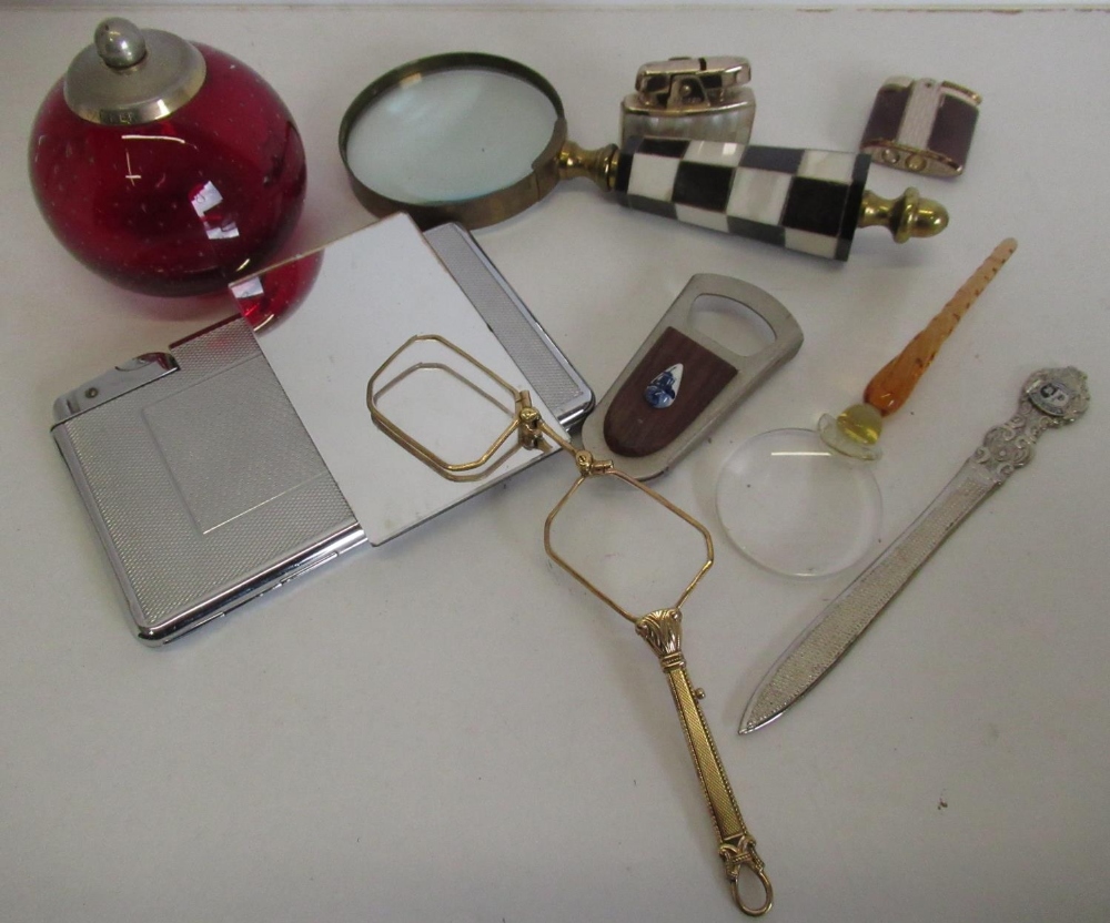 Large magnifying glass with checked handle and yellow metal frame another smaller magnifying glass