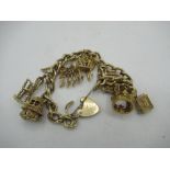 9ct gold hallmarked charm bracelet hung with seven charms, including enamelled rabbit in toadstool