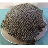 British army issue steel helmets stamped 1/1940 with liner and strap, with remnants of camo netting