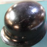 German WWII period black steel helmet (no decals) rolled edge SS style with two drilled holes to the