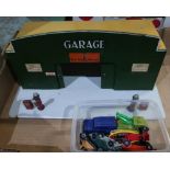 A wooden toy garage with Shell advertising and small quantity of toy cars inc. Corgi and other in