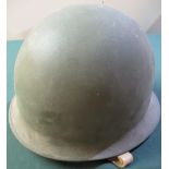 Post WWII French issue combat helmet, with steel outer complete with liner and straps