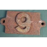 A cast iron wagon plate stamped 9