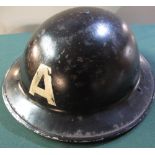 British WWII period black C.D civil defence helmet with liner and chinstrap, marked "A" (for