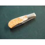 Small twin bladed pocket knife with polished grips