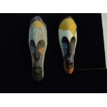 A pair of tourist piece tribal masks with ornate carving and coloured design measuring approx