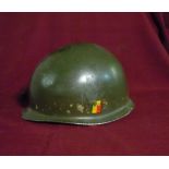 USA occupation of Berlin post WWII steel helmet with chin strap, lacking liner, with traces of decal