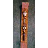 A piece of African carved tribal art on a wooden frame approx 87cm long