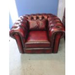 Small red Ox blood leather Chesterfield chair, with deep buttoned back and arms, two seat cushions